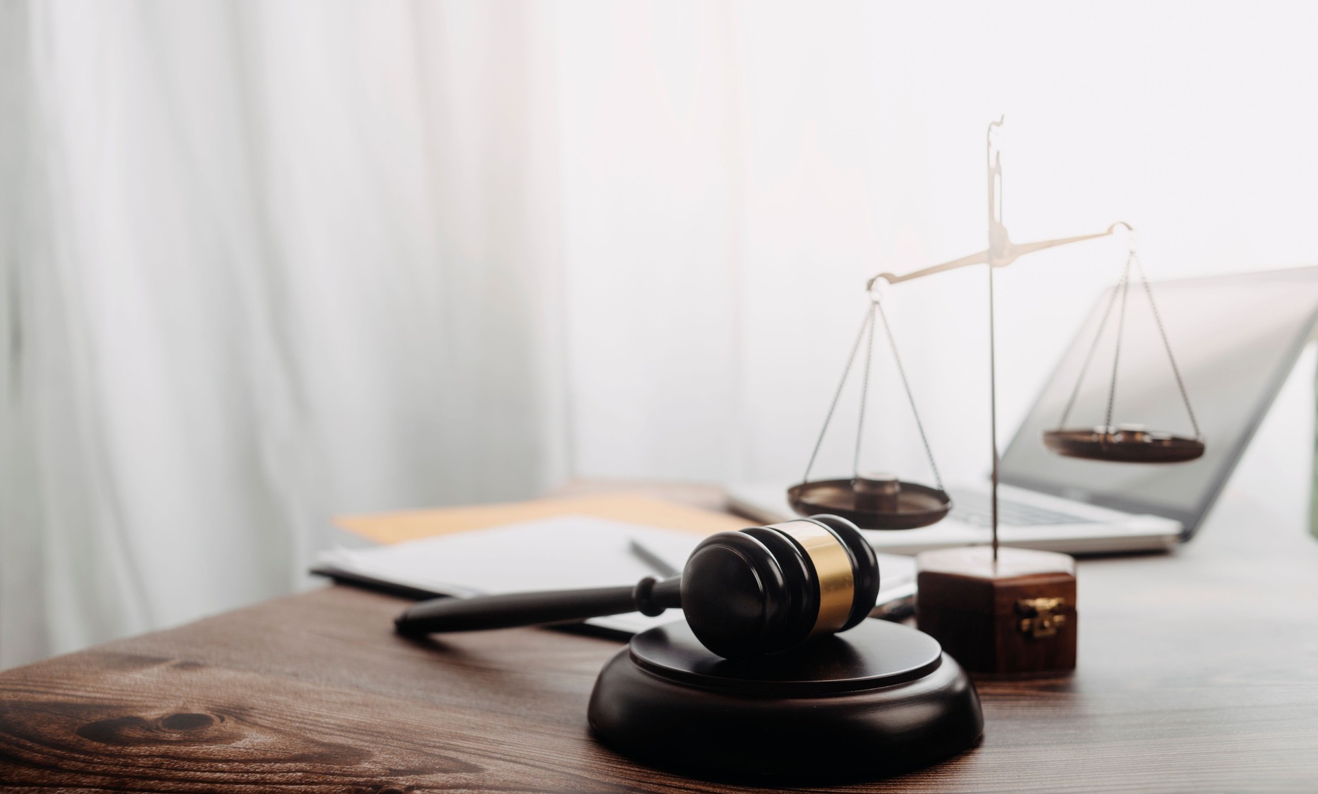 Business and lawyers discussing contract papers with brass scale on desk in office. Law, legal services, advice, justice and law concept picture with film grain effect